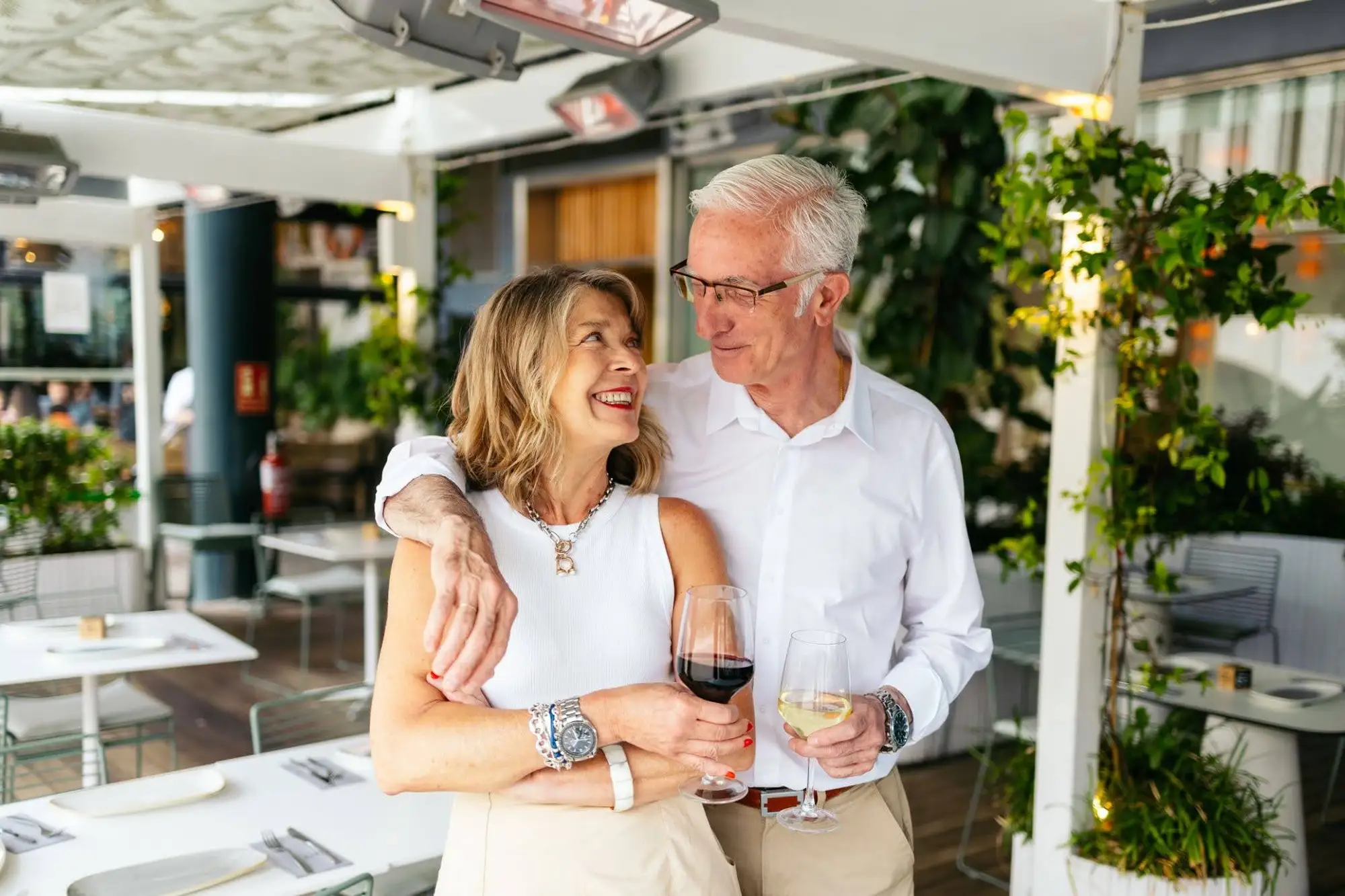 Tips on downizing for seniors for luxury independent living An elderly couple talking about downsizing for seniors and moving into a luxury independent living community in Miami like The Contemporary.